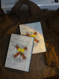 two cds sitting on top of a piece of paper