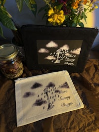 two pouches with flowers and a bottle of water