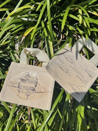 two tote bags with drawings on them