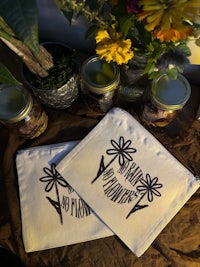 two pouches with flowers on them next to a table