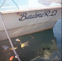 a boat in the water with a sign on it