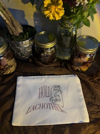 jars of flowers and herbs on a table