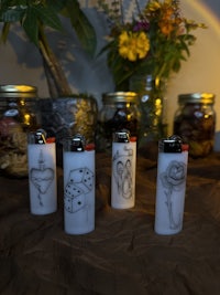 a group of lighters on a table with a rainbow in the background